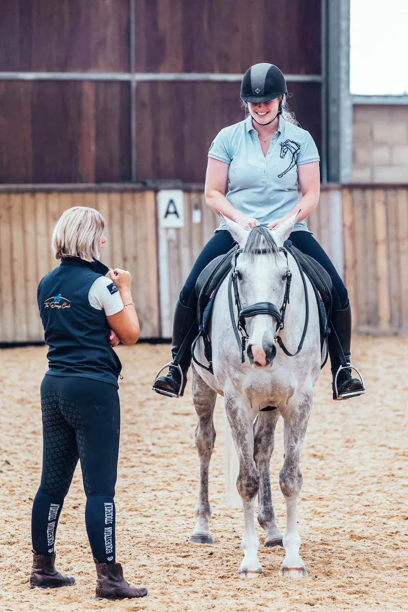 A dressage rider riding a dressage horse in a dressage coaching session