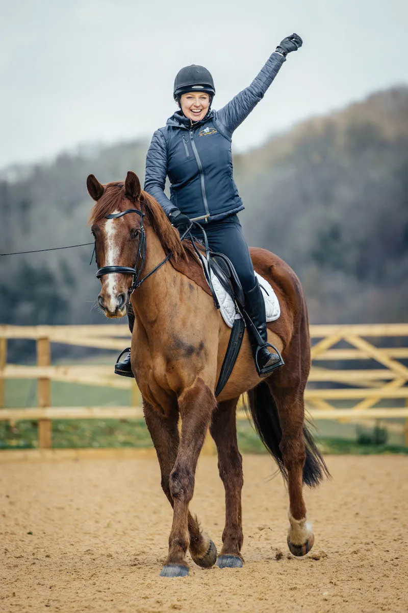 A dressage rider riding a dressage horse in a dressage coaching session
